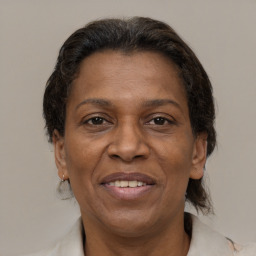 Joyful latino adult female with medium  brown hair and brown eyes