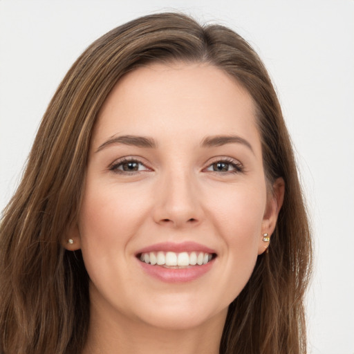 Joyful white young-adult female with long  brown hair and grey eyes