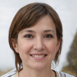 Joyful white young-adult female with medium  brown hair and brown eyes