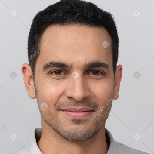 Joyful white young-adult male with short  black hair and brown eyes