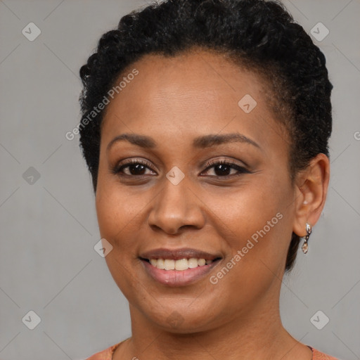 Joyful black young-adult female with short  brown hair and brown eyes