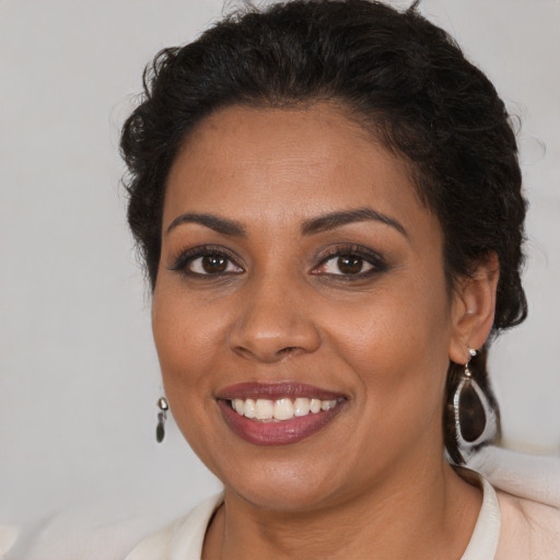 Joyful black young-adult female with medium  brown hair and brown eyes