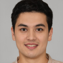 Joyful latino young-adult male with short  brown hair and brown eyes