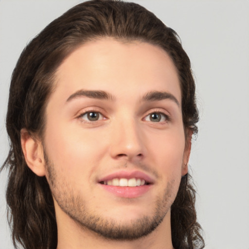 Joyful white young-adult male with medium  brown hair and brown eyes