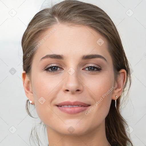 Joyful white young-adult female with long  brown hair and grey eyes