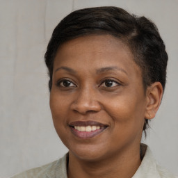 Joyful black adult female with short  brown hair and brown eyes