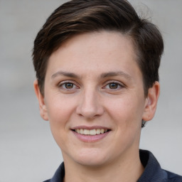 Joyful white young-adult female with short  brown hair and grey eyes