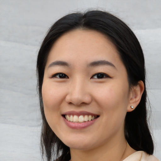 Joyful white young-adult female with medium  black hair and brown eyes