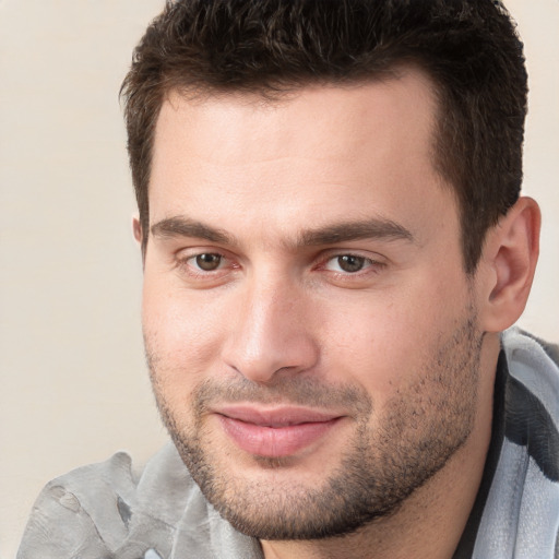 Joyful white young-adult male with short  brown hair and brown eyes