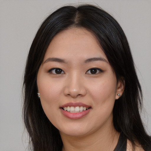 Joyful asian young-adult female with long  brown hair and brown eyes