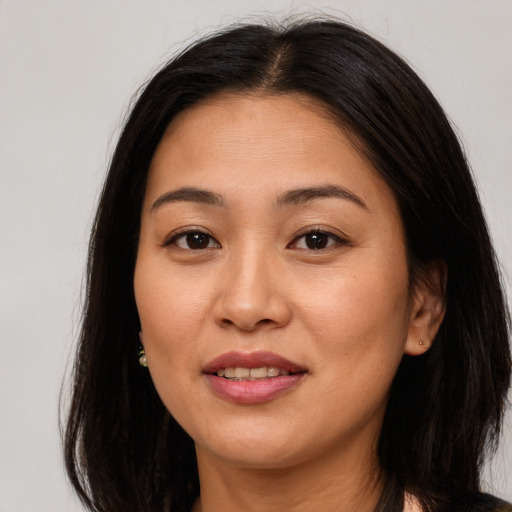 Joyful asian young-adult female with long  brown hair and brown eyes