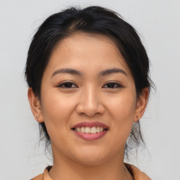 Joyful asian young-adult female with medium  brown hair and brown eyes