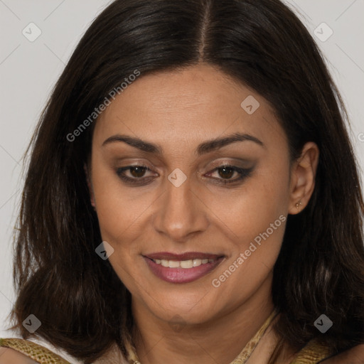 Joyful latino adult female with long  brown hair and brown eyes