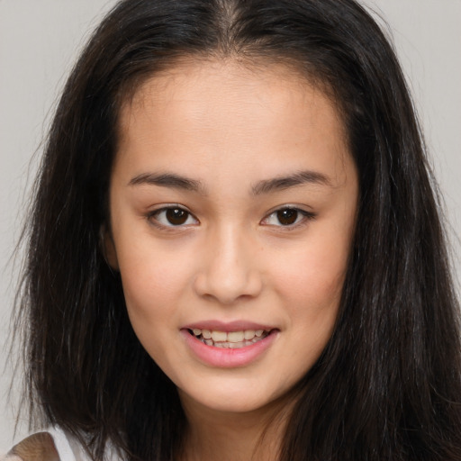 Joyful asian young-adult female with long  brown hair and brown eyes