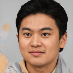 Joyful asian young-adult male with short  black hair and brown eyes