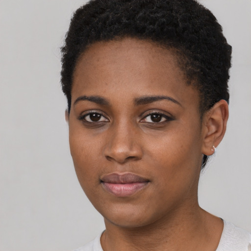 Joyful black young-adult female with short  black hair and brown eyes