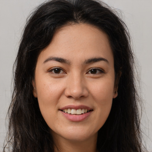 Joyful latino young-adult female with long  brown hair and brown eyes