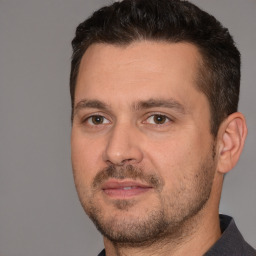 Joyful white adult male with short  brown hair and brown eyes