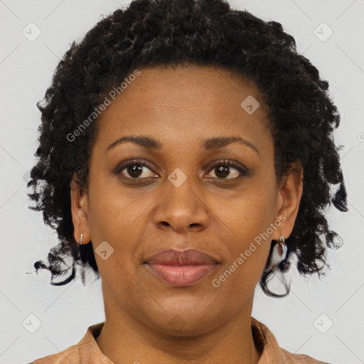 Joyful black adult female with short  brown hair and brown eyes