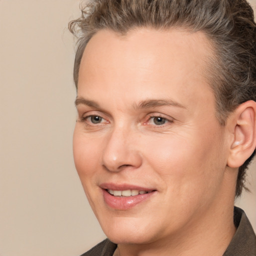 Joyful white adult female with short  brown hair and brown eyes