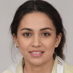 Joyful latino young-adult female with medium  brown hair and brown eyes