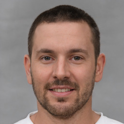 Joyful white young-adult male with short  brown hair and brown eyes