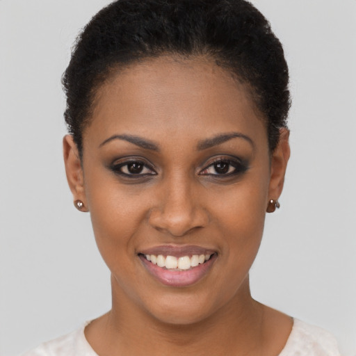 Joyful black young-adult female with short  brown hair and brown eyes
