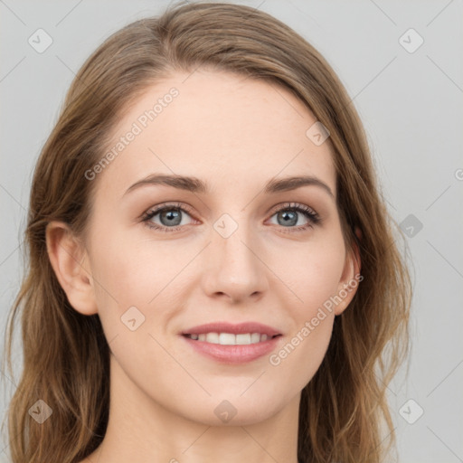 Joyful white young-adult female with long  brown hair and blue eyes