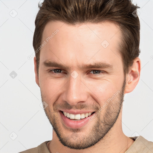 Joyful white young-adult male with short  brown hair and brown eyes