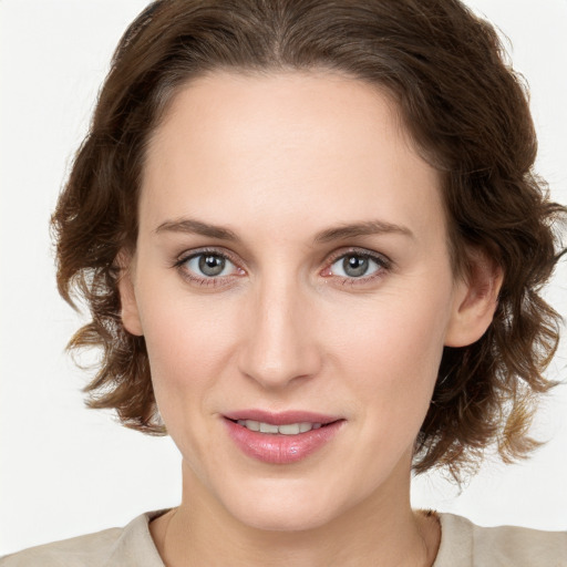 Joyful white young-adult female with medium  brown hair and green eyes