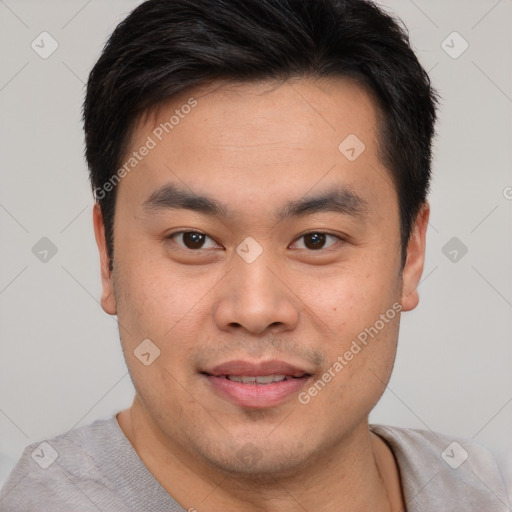 Joyful asian young-adult male with short  brown hair and brown eyes