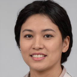 Joyful white young-adult female with medium  brown hair and brown eyes