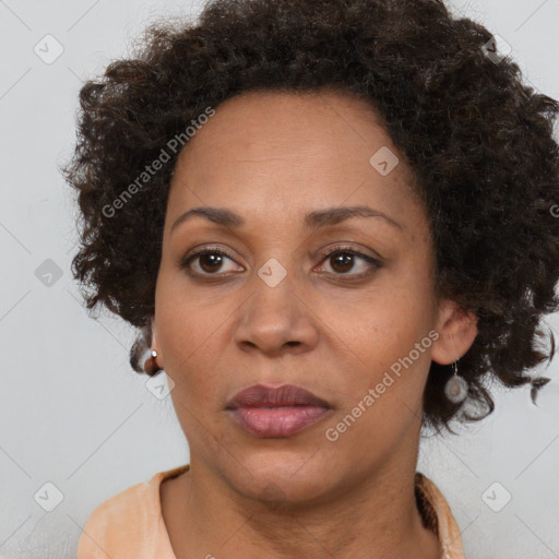 Joyful black adult female with medium  brown hair and brown eyes