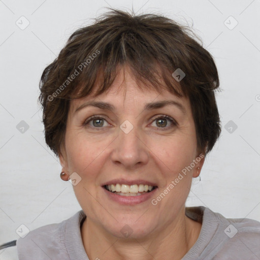 Joyful white adult female with short  brown hair and grey eyes