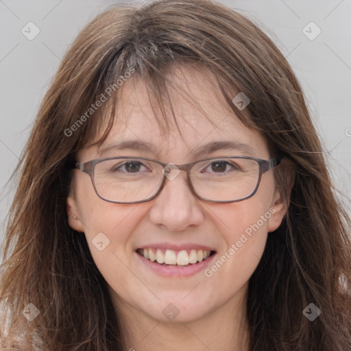 Joyful white adult female with long  brown hair and grey eyes