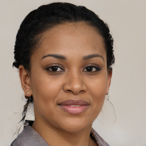 Joyful black young-adult female with medium  brown hair and brown eyes