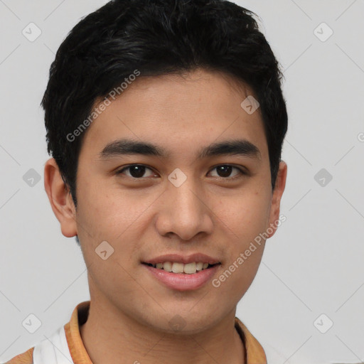 Joyful latino young-adult male with short  brown hair and brown eyes