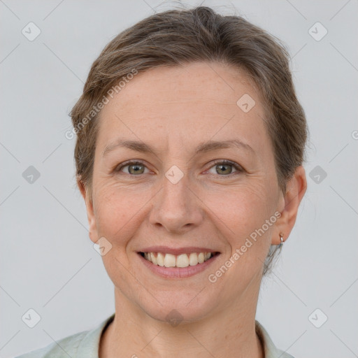 Joyful white adult female with short  brown hair and grey eyes