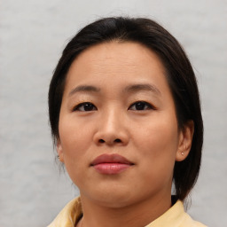 Joyful asian young-adult female with medium  brown hair and brown eyes