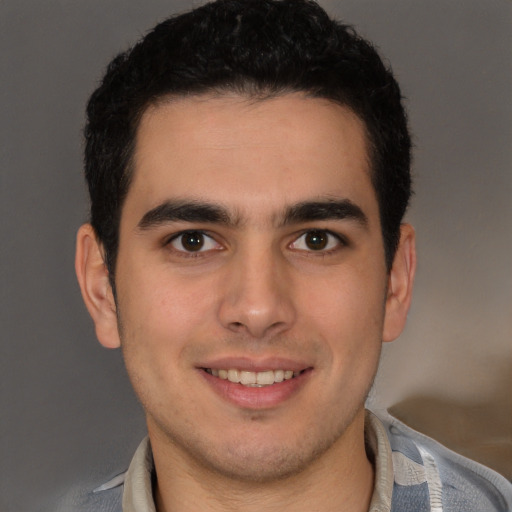 Joyful latino young-adult male with short  brown hair and brown eyes