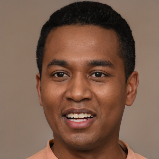 Joyful black young-adult male with short  black hair and brown eyes