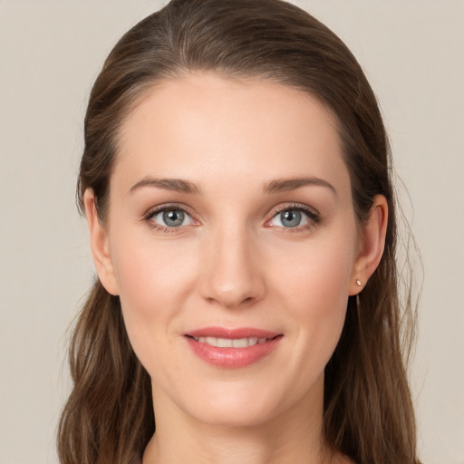 Joyful white young-adult female with long  brown hair and grey eyes