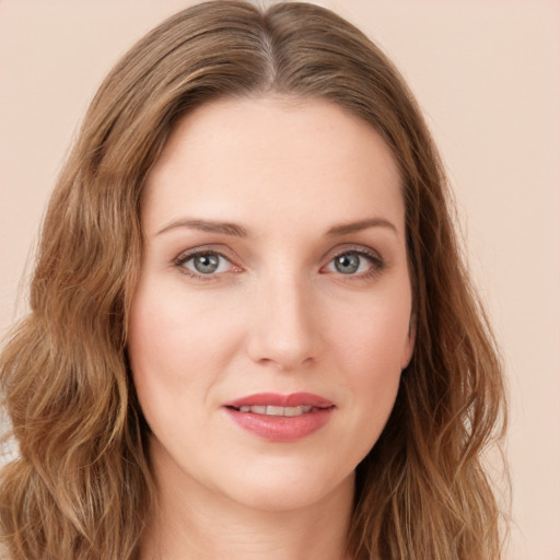 Joyful white young-adult female with long  brown hair and green eyes