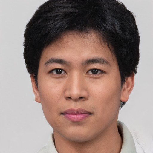 Joyful asian young-adult male with short  brown hair and brown eyes