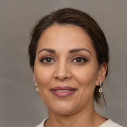 Joyful white adult female with medium  brown hair and brown eyes