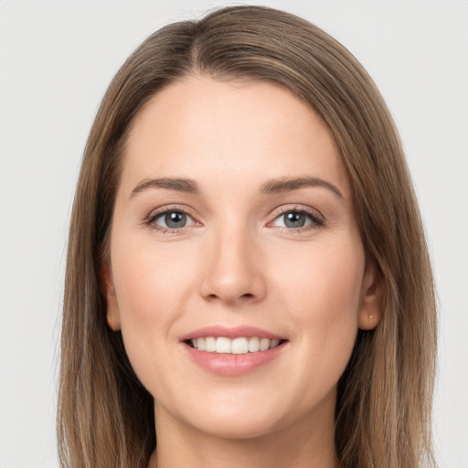 Joyful white young-adult female with long  brown hair and grey eyes