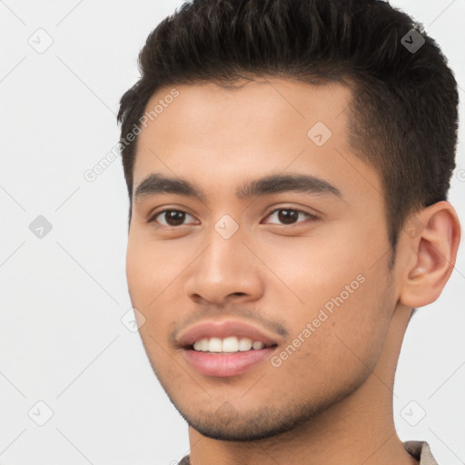 Joyful white young-adult male with short  black hair and brown eyes