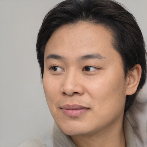 Joyful asian young-adult female with medium  brown hair and brown eyes