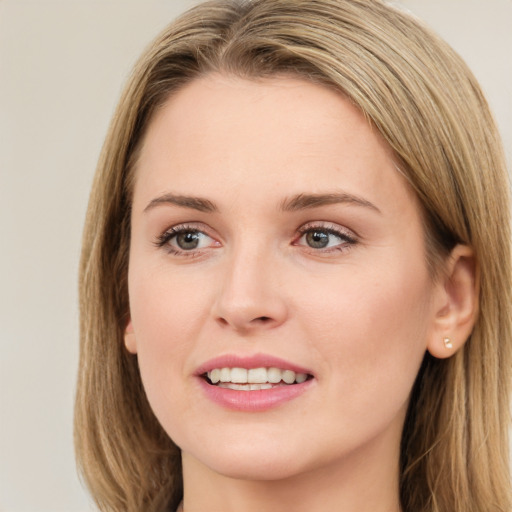 Joyful white young-adult female with long  brown hair and green eyes