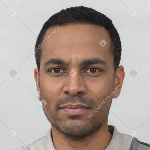 Neutral latino young-adult male with short  black hair and brown eyes
